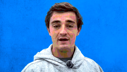 nick shirley in a gray hoodie before a blue background